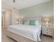 Relaxing bedroom with a queen-sized bed, two nightstands with lamps, and neutral color scheme at 17505 Opal Sand Dr # 101, Venice, FL 34293