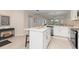 Bright kitchen showcasing white cabinetry, stainless steel appliances, and center island with seating at 17505 Opal Sand Dr # 101, Venice, FL 34293