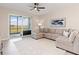 Comfortable living room with a large sectional sofa, area rug, and sliding glass doors offering scenic views at 17505 Opal Sand Dr # 101, Venice, FL 34293