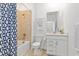 Well-lit bathroom featuring a bathtub with tiled wall, modern vanity, and decorative shower curtain at 17685 Boracay Ct # 202, Venice, FL 34293