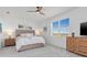 Bright bedroom with a large window, ceiling fan, and light wood furniture, creating a serene retreat at 17685 Boracay Ct # 202, Venice, FL 34293