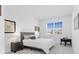 Cozy bedroom with a neutral color scheme, large window, and tasteful decor at 17685 Boracay Ct # 202, Venice, FL 34293