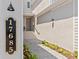 Inviting walkway to a home with clear signage, a well-lit exterior, and lush, green landscaping at 17685 Boracay Ct # 202, Venice, FL 34293