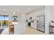 Bright modern kitchen with stainless steel appliances, a large island, and bar seating with balcony access at 17685 Boracay Ct # 202, Venice, FL 34293