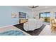 Cozy living room features a comfortable white sofa, stylish console, and scenic views from the screened balcony at 17685 Boracay Ct # 202, Venice, FL 34293