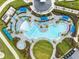 Aerial view of a resort-style pool with lounge chairs, umbrellas, and well-manicured landscaping, ideal for relaxation and recreation at 17685 Boracay Ct # 202, Venice, FL 34293