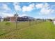 Expansive backyard showing the full fencing surrounding the property and a screened-in pool at 18 Annapolis Ln, Rotonda West, FL 33947