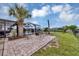 This peaceful backyard features a charming patio with chairs and a screened pool, perfect for entertaining at 18 Annapolis Ln, Rotonda West, FL 33947