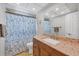 This bathroom features a granite countertop, tile floors, and a shower behind a curtain at 18 Annapolis Ln, Rotonda West, FL 33947