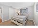 This well-lit bedroom has a large closet, a queen bed and wood-look flooring at 18 Annapolis Ln, Rotonda West, FL 33947