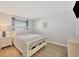 Cozy bedroom featuring wood-look flooring, a queen bed, and coastal decor at 18 Annapolis Ln, Rotonda West, FL 33947
