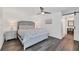 Modern bedroom features an ensuite bathroom, ceiling fan and laminate wood flooring at 18 Annapolis Ln, Rotonda West, FL 33947