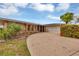 Single story home with a circular driveway, well-maintained lawn, and attached garage at 18 Annapolis Ln, Rotonda West, FL 33947