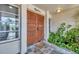 Inviting front entryway with slate tile and potted greenery at 18 Annapolis Ln, Rotonda West, FL 33947