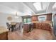 Kitchen island features a stainless steel stove with a view to the breakfast nook and backyard at 18 Annapolis Ln, Rotonda West, FL 33947
