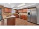 Beautiful kitchen with granite countertops, wood cabinets, stainless steel appliances, and wood-look tile flooring at 18 Annapolis Ln, Rotonda West, FL 33947