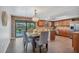Kitchen and dining room with backyard pool view. Dining table has seating for six at 18 Annapolis Ln, Rotonda West, FL 33947