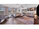 Inviting living room with wood floors, neutral colors, and ample natural light at 18 Annapolis Ln, Rotonda West, FL 33947