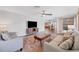 Bright living room featuring hardwood floors and an open-concept design with a kitchen view at 18 Annapolis Ln, Rotonda West, FL 33947