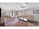 Spacious living room with hardwood floors, ample seating, and large windows at 18 Annapolis Ln, Rotonda West, FL 33947