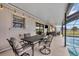 Covered, screened patio with a dining table and outdoor seating with a pool view at 18 Annapolis Ln, Rotonda West, FL 33947