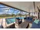 Screened-in patio featuring an inviting pool and ample wicker seating at 18 Annapolis Ln, Rotonda West, FL 33947
