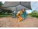 Community playground offers various play areas, including slides and climbing apparatus at 18 Annapolis Ln, Rotonda West, FL 33947