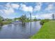 The tranquil waterfront view features a well-maintained canal and a boat docked alongside the property at 18 Annapolis Ln, Rotonda West, FL 33947