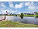 A peaceful waterfront view showcasing a dock and an American flag waving in the distance at 18 Annapolis Ln, Rotonda West, FL 33947