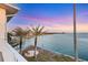Stunning backyard view showcases waterfront access, a cozy seating area, and tropical palm trees at 1905 Mississippi Ave, Englewood, FL 34224