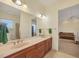 Bathroom with a double sink vanity, tile flooring, and shower visible in the mirror at 1905 Mississippi Ave, Englewood, FL 34224