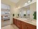 Bright bathroom featuring double sink vanity and bedroom view through open doorway at 1905 Mississippi Ave, Englewood, FL 34224