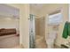Bathroom showcases a tub with shower, toilet, and a window with natural light at 1905 Mississippi Ave, Englewood, FL 34224