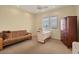 Bedroom with a sewing machine, futon, and dresser with a bright window at 1905 Mississippi Ave, Englewood, FL 34224
