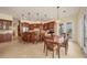 Spacious kitchen featuring custom wood cabinets, stainless appliances, and an island bar at 1905 Mississippi Ave, Englewood, FL 34224