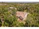 Aerial shot of a home with a well-maintained roof, garden, and lush landscaping at 2020 E Dolphin Dr, Englewood, FL 34223
