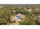 Overhead shot of a pool and patio with deck offering a relaxing outdoor space surrounded by lush trees at 2020 E Dolphin Dr, Englewood, FL 34223