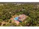 An aerial view showcasing the home's pool, patio, and secluded backyard at 2020 E Dolphin Dr, Englewood, FL 34223