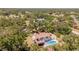 A serene aerial shot of a home featuring a pool, deck, and lush surroundings at 2020 E Dolphin Dr, Englewood, FL 34223