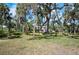 A lush, tropical backyard offers a serene view and includes kayaks for enjoying waterfront activities at 2020 E Dolphin Dr, Englewood, FL 34223