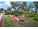 This backyard seating area is surrounded by a lush green lawn and lots of trees at 2020 E Dolphin Dr, Englewood, FL 34223