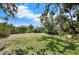 Spacious backyard with shed, kayak, and tall trees at 2020 E Dolphin Dr, Englewood, FL 34223