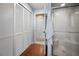 Bathroom featuring tiled floors, a set of closets, and a glass door shower at 2020 E Dolphin Dr, Englewood, FL 34223