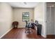 Bright bedroom with hardwood floors and a view of lush greenery at 2020 E Dolphin Dr, Englewood, FL 34223