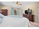 Bedroom with a four poster bed, windows, blue curtains, and a dresser with a TV at 2020 E Dolphin Dr, Englewood, FL 34223