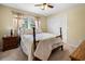 Bedroom with a four post bed, ceiling fan, two windows, and a closet at 2020 E Dolphin Dr, Englewood, FL 34223