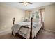 Bedroom with a four post bed, ceiling fan, and two windows with curtains at 2020 E Dolphin Dr, Englewood, FL 34223