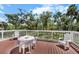 Outdoor brown wood deck overlooking a lush, green landscape at 2020 E Dolphin Dr, Englewood, FL 34223