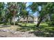A beautiful home surrounded by lush trees and landscaping provides a sense of privacy and tranquility at 2020 E Dolphin Dr, Englewood, FL 34223