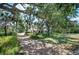 An expansive home with a long driveway and mature trees offering shade and privacy at 2020 E Dolphin Dr, Englewood, FL 34223